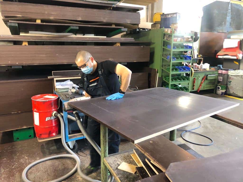 Man fixing large metal sheet