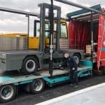 Large sideloader being loaded onto lorry