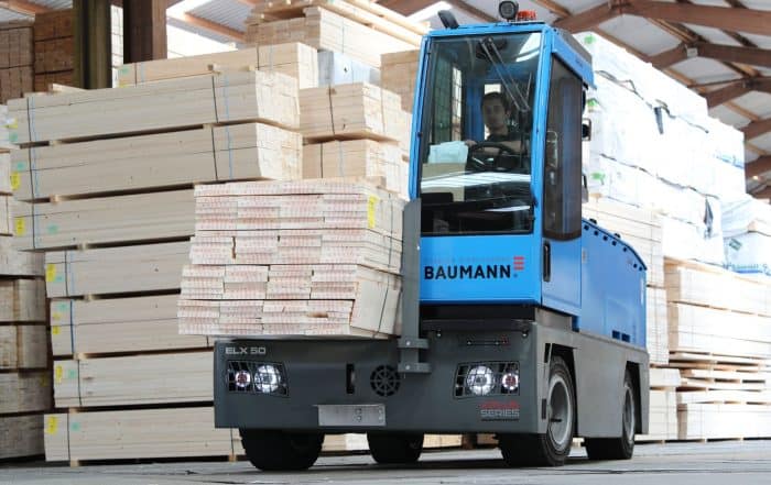 Baumann sideloader lifting wood in factory